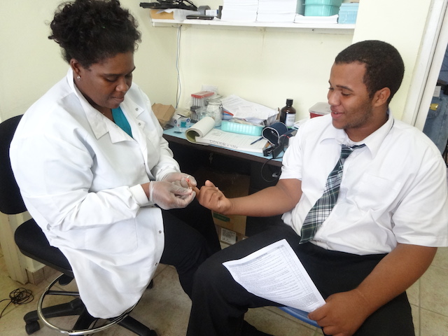Nurse Janine doing an iron level test to a student donor