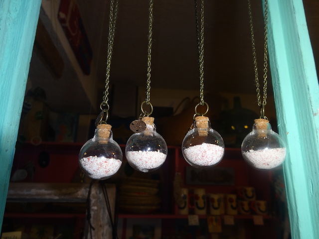 Necklaces with Eleutheran pink sand in a glass bottle.... lovely idea.....