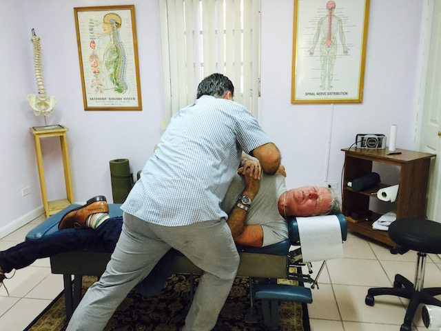 Michael Pyfrom giving Bob a chiropractic treatment.