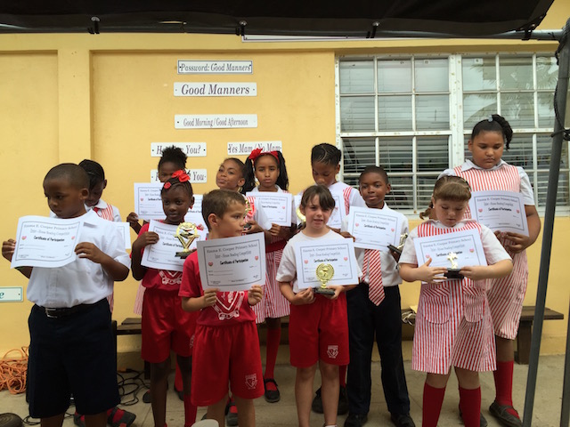 All the participants with their certificates. Note the reminders for good manners on the wall behind the children......