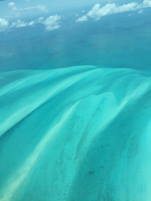 The waters of the Bahamas still charm when viewed from the plane.....