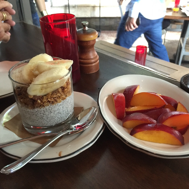 Coconut lemon chia pudding with granola and banana with a side of the most perfectly ripe nectarines also at Michaels GFD 