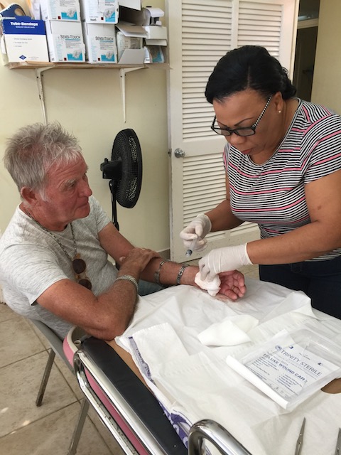 Nurse Debbie Deal at the Levy Clinic stitching Bob up 