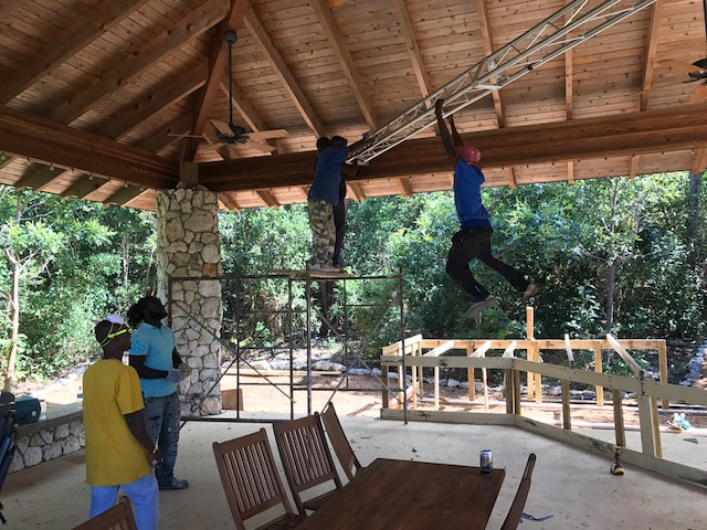 Testing the strength of the lighting bar - actually Bob bet one of our young workers that he couldn't monkey walk across the bar - he did and it cost Bob $10 !! 