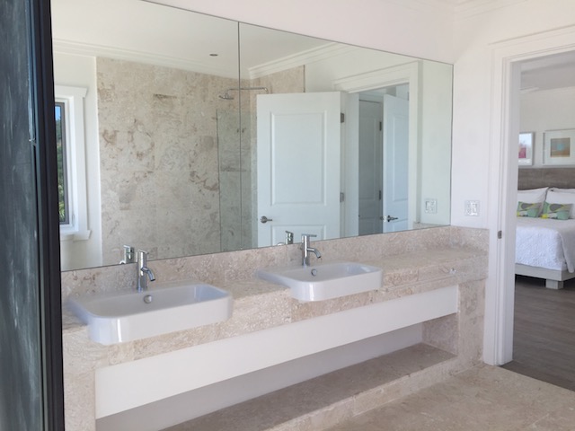 I used corolina tile on the floors and in all the bathrooms - a) because I love a sense of continuity and b) because this natural stone is perfect for an island setting