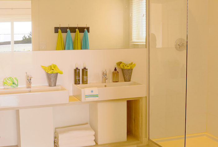 A shot of the main bedroom 's en-suite bathroom - with the towels reflected in the large mirror