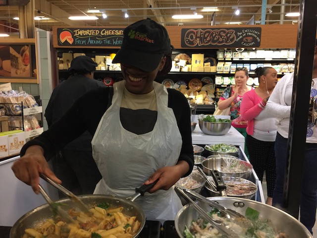 The smiling cook in FreshMarket with 2 pans on the go .....