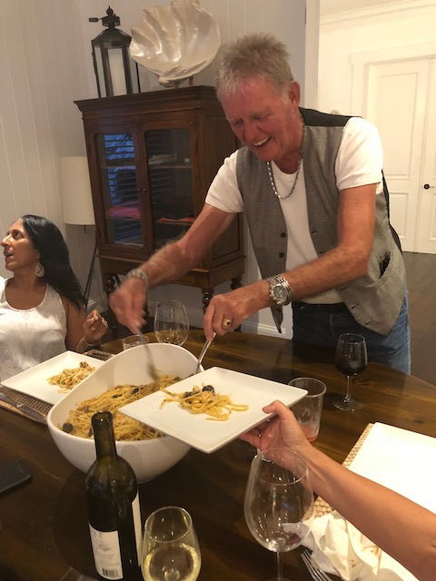 Bob serving out seafood pasta with the amazing superwoman - known as Michele Johnson in the background.